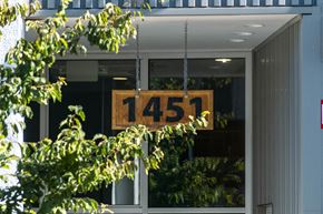 Portland apartment for rent - A sign with the number 1451 hanging in front of a window.