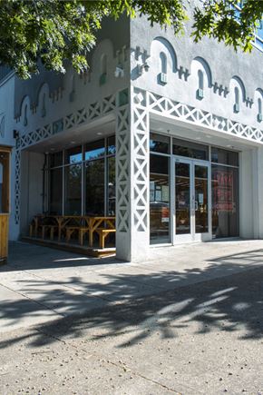 Portland apartment for rent - A storefront with a white facade and a large window.