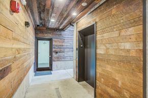 Portland apartment for rent - a hallway with two doors in a wood walled building