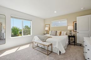 Oregon City townhouse for rent - Bright bedroom with large windows and neutral tones at Holmes Park Townhomes Apartments, Oregon City, 97045