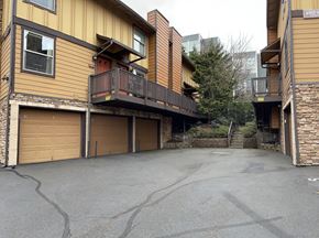 Portland townhouse for rent - a driveway with two garages in front of a house