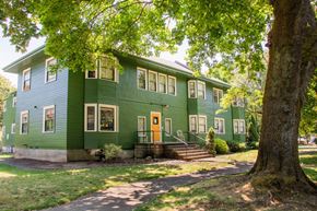 Portland apartment for rent - a green house with trees in front of it