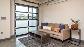 Portland apartment for rent - A living room with a couch, coffee table, and a plant.