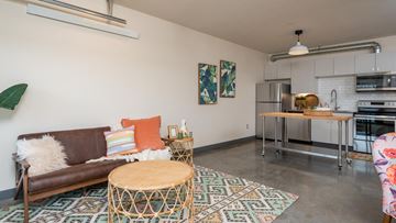 Portland apartment for rent - A living room with a brown couch and a woven table.