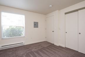 Portland apartment for rent - A room with a window, a door, and a wall-mounted thermostat.