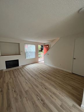 Portland townhouse for rent - an empty living room with hardwood floors