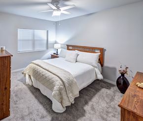 Hayward apartment for rent - A bedroom with a large bed and a ceiling fan.
