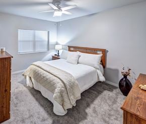 St Croix Falls apartment for rent - A bedroom with a large bed and a ceiling fan.