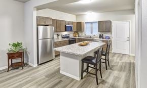 St Croix Falls apartment for rent - A kitchen with a table and chairs in the middle of the room.