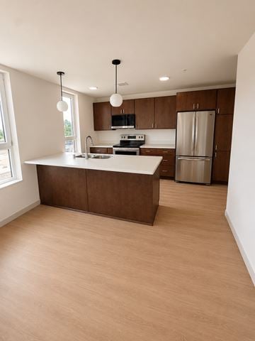 Stevens Point apartment for rent - A kitchen with wooden cabinets and a white countertop.