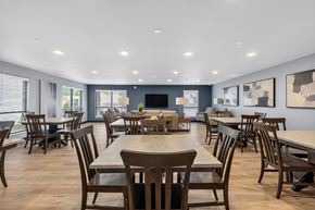 Oshkosh townhouse for rent - A large dining room with wooden chairs and tables.