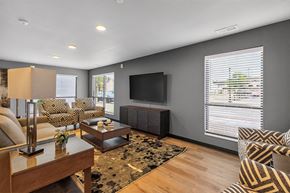 Oshkosh townhouse for rent - A living room with a television, a sofa, and a coffee table.