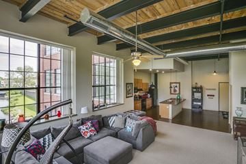 Beaver Dam apartment for rent - a living room with a gray couch and a large window