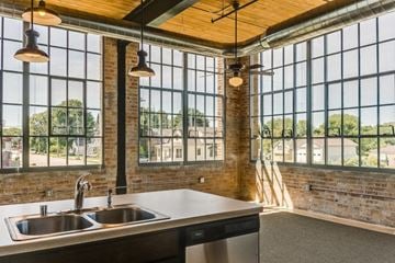 Manitowoc apartment for rent - a kitchen with a sink and large windows