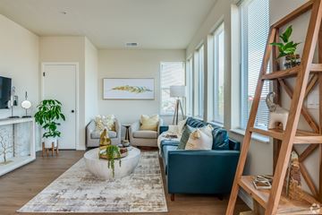 Saukville apartment for rent - A living room with a blue couch and a white coffee table.