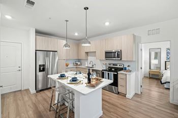 A modern kitchen with a dining table set for two