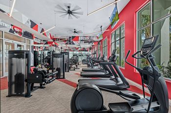 A gym with treadmills and other exercise equipment.