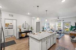 Orlando apartment for rent - A modern kitchen with white cabinets and a large island.at Altis Grand Lake Willis, Orlando