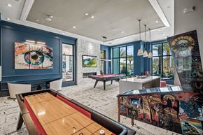 Land O' Lakes apartment for rent - a view of a long row of differently colored urinals at Altis Grand Suncoast, Land O' Lakes, 34638