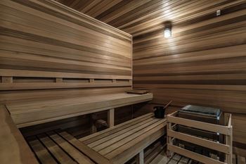 A sauna with wooden benches and a table
