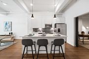 St. Louis apartment for rent - a kitchen with an island and stools in a 555 waverly unit