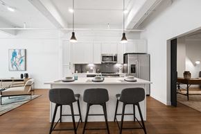 St. Louis apartment for rent - a kitchen with an island and stools in a 555 waverly unit