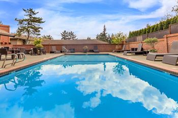 Seasonal outdoor swimming pool with loungers