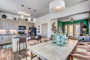 Lewisville apartment for rent - Apartments Lewisville TX - Hebron 121 Station - Modern Kitchen With Sleek Counters and Dining Room Table Equipped With Wooden Chairs