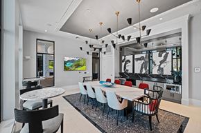 Land O' Lakes apartment for rent - a dining room with a long table and chairs and a living room at Altis Grand Suncoast, Florida