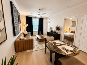 Atlanta apartment for rent - A dining room with a table set for two and a couch.