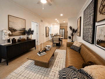 Atlanta apartment for rent - A living room with a brown leather couch and a wooden coffee table.