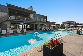 Bozeman apartment for rent - A pool area with a building in the background.