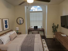 Atlanta apartment for rent - A bedroom with a large bed and a ceiling fan.
