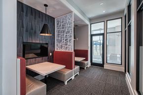 Land O' Lakes apartment for rent - a dining room with tables and chairs and a television at Altis Grand Suncoast, Land O' Lakes, FL