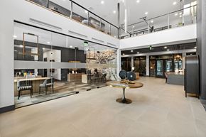 Bozeman apartment for rent - A modern open space with a central table and chairs.