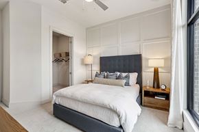 Cumming apartment for rent - A bedroom with a large bed and a ceiling fan.