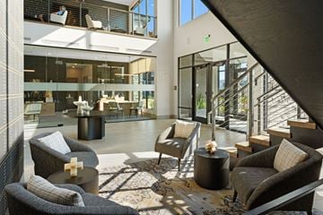 Bozeman apartment for rent - a living room with couches and chairs and a staircase