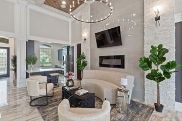Tallahassee apartment for rent - a living room with a couch and chairs and a fireplace