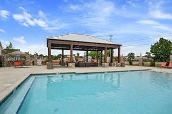 Swimming pool w/ sundeck & lounge seating areas