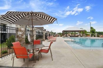 Swimming pool w/ sundeck & lounge seating areas