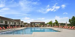 Madison apartment for rent - A swimming pool surrounded by red chairs and a gazebo.