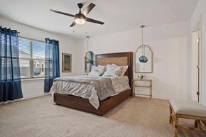 Madison apartment for rent - A bedroom with a bed, a chair, and a ceiling fan.