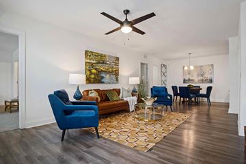 Madison apartment for rent - A living room with a blue chair and a painting on the wall.