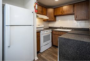 Knoxville apartment for rent - a kitchen with a white refrigerator freezer next to a white stove top oven