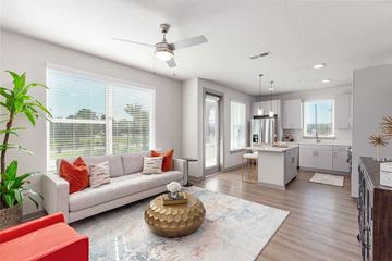 Daytona Beach apartment for rent - a living room and kitchen with a couch and a table