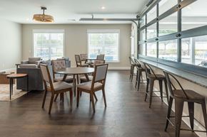 Chattanooga apartment for rent - a dining room with tables and chairs in a building with large windows