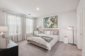 Bradenton apartment for rent - A bedroom with a large bed and a painting on the wall.