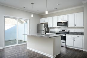 Ooltewah apartment for rent - an empty kitchen with white cabinets and a counter top