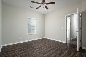 Ooltewah apartment for rent - a living room with wood floors and a ceiling fan