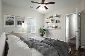 Chattanooga apartment for rent - a bedroom with a large bed and a ceiling fan